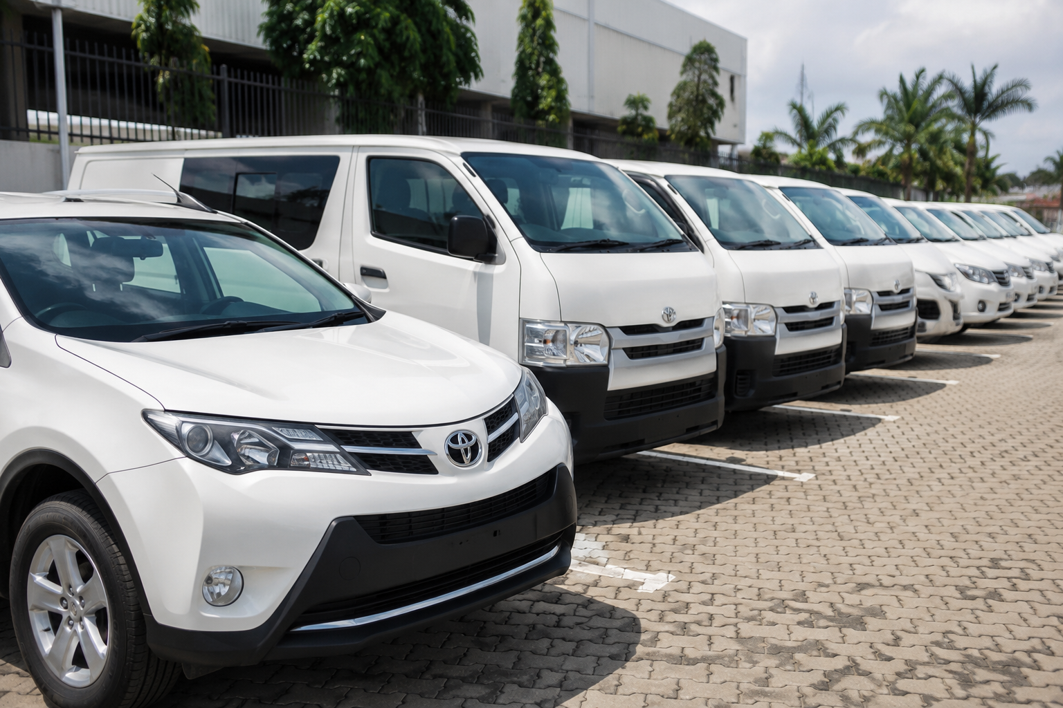 A photograph of a managed customer fleet on the road or at a depot: trucks, vans or buses. Real vehicles, ideally Nigerian roads.